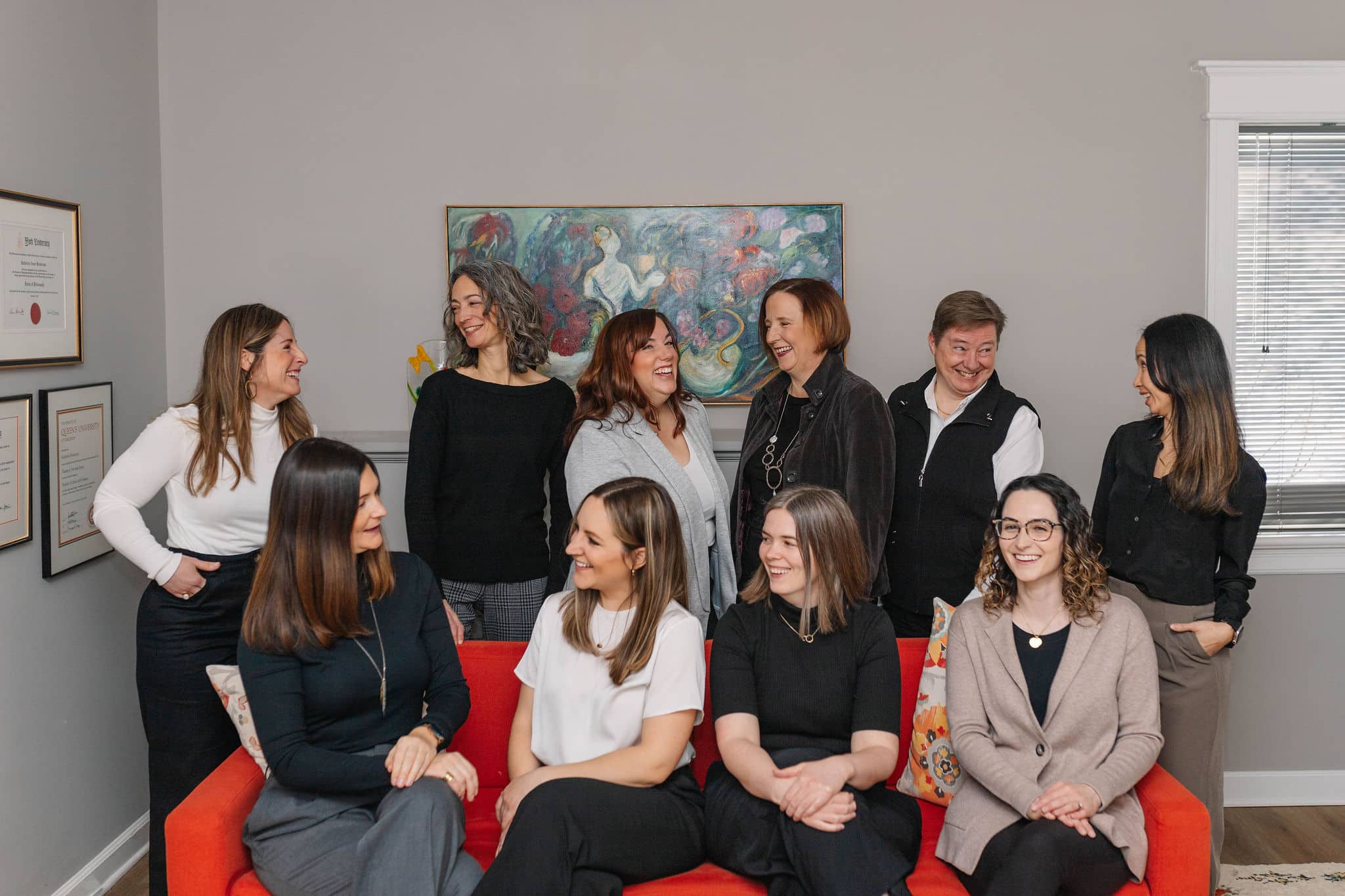 Group of women posing together indoors.
