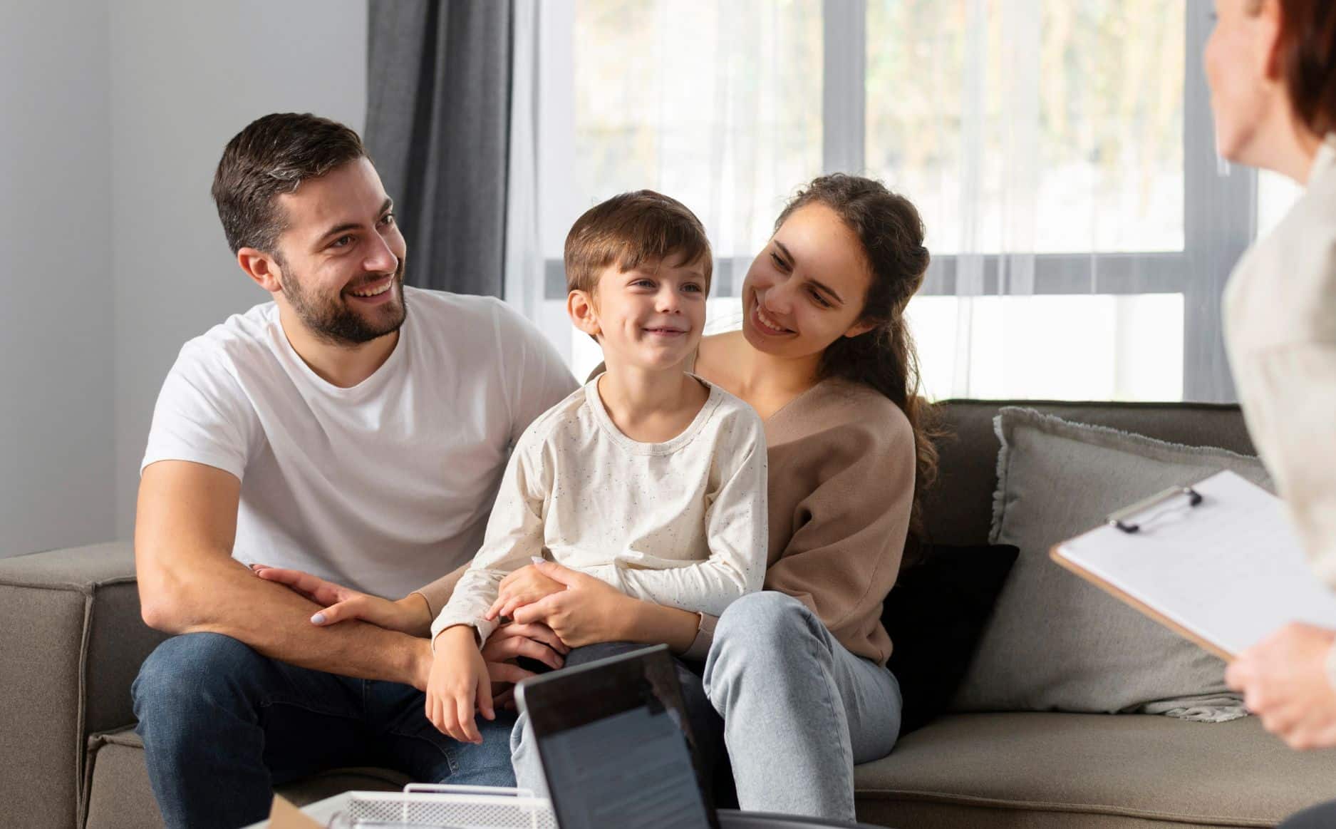 Family sitting together in living room.