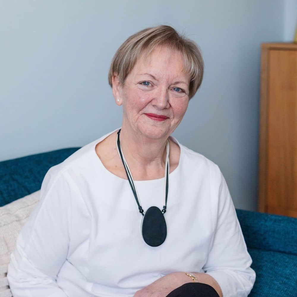 Woman sitting on a blue couch.