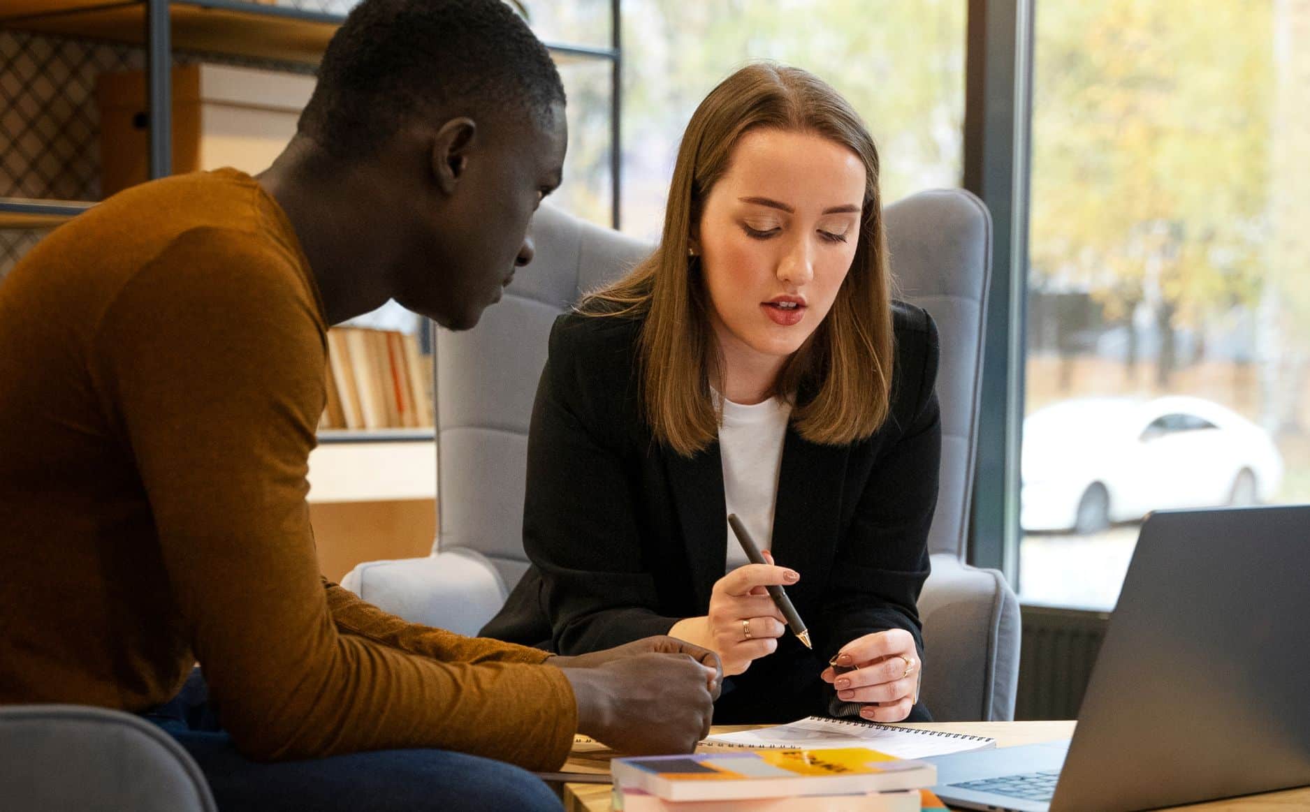Two people discussing at a table.