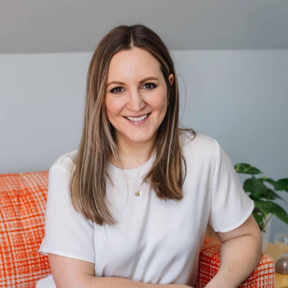 Person sitting on orange couch.