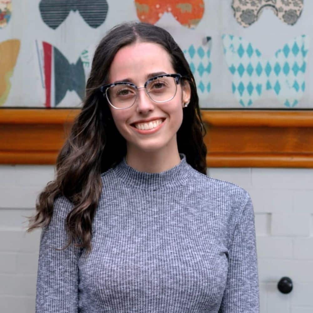 Person with long hair in sweater.